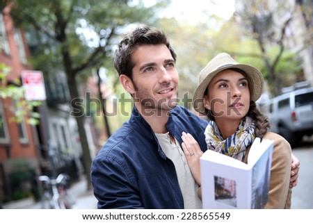 Couple with tourist guide book in Greenwich village, NYC