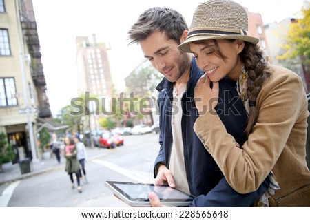 Couple in town connected on digital tablet