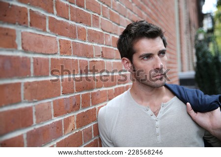 Man leaning on wall in the street
