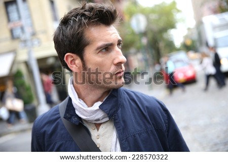 Casual guy crossing shopping street in Greenwich village