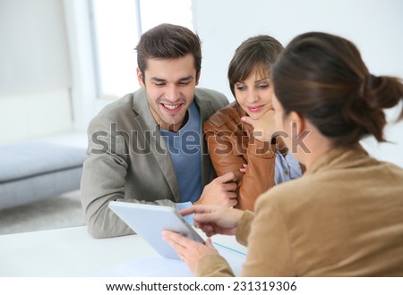 Young couple meeting real estate agent