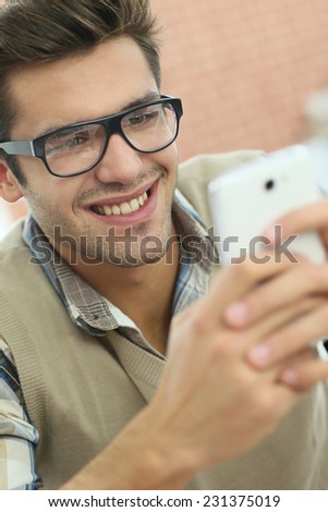 Young man connected on internet with smartphone