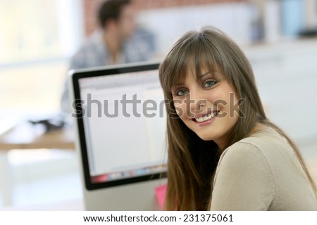 Student girl sitting in front of desktop computer