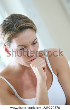 Middle-aged woman having a cold and coughing