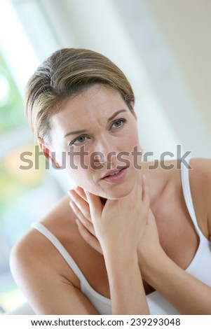 Middle-aged woman having a cold and coughing