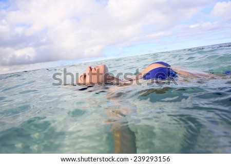 Closeup of woman floating in lagoon water