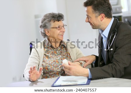 Doctor visiting elderly patient at home