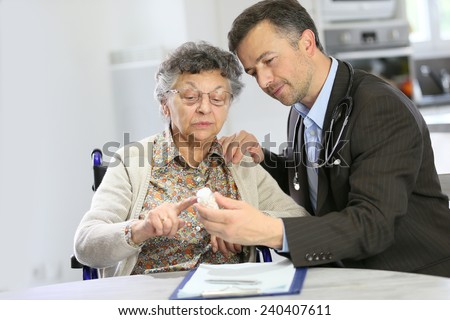 Doctor visiting elderly patient at home