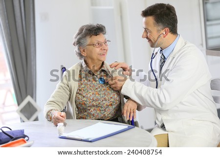 Doctor examining elderly woman in nursing home