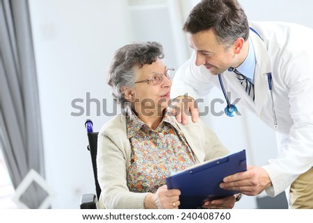 Doctor with elderly woman in nursing home