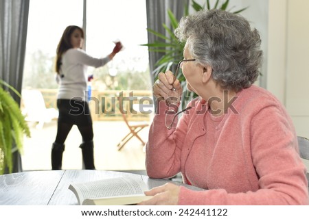 Elderly woman in nursing home reading book