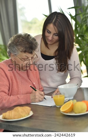 Young woman visiting elderly woman in nursing home