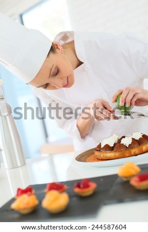 Pastry-cook shreding lemon zest over chocolate cake