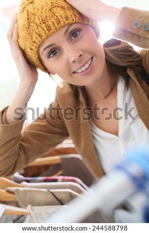 Attractive woman in store trying hat on