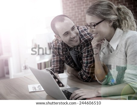 Young people at home websurfing on laptop