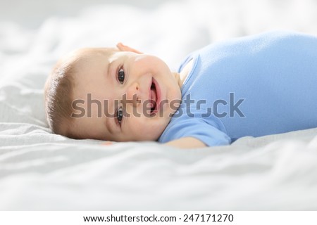 8-month-old baby boy laying on bed