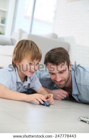 Daddy with little boy playing with toy cars