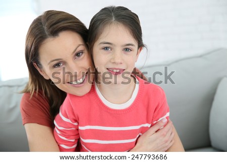 Portrait of mother and daughter with red shirt