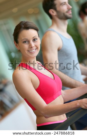 Couple doing cardio training program in fitness center
