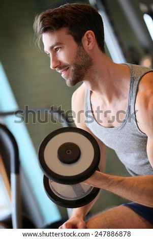Man lifting weights in fitness center
