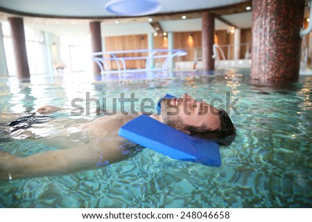 Man in spa pool doing exercises for muscular recovery