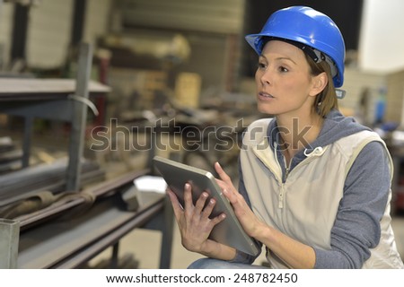 Woman engineer in steel plant using tablet