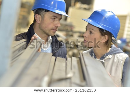 Supplier with engineer checking on production in factory