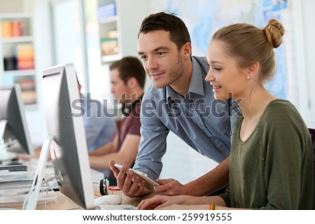 Student girl with trainer working on computer and tablet