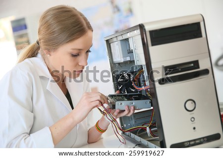 Student girl in technology fixug computer hard drive