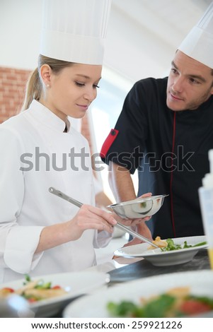 Girl in cooking training class with chef