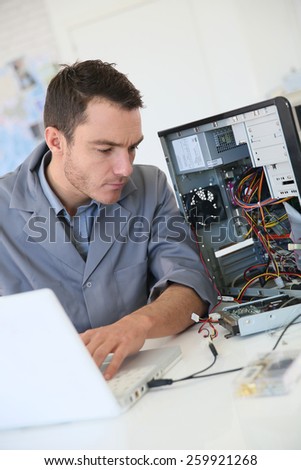 Technician fixing computer hardware