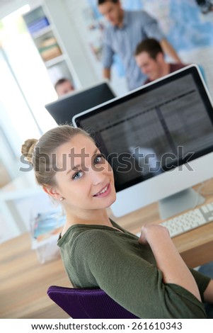 Portrait of student girl sitting in front of desktop