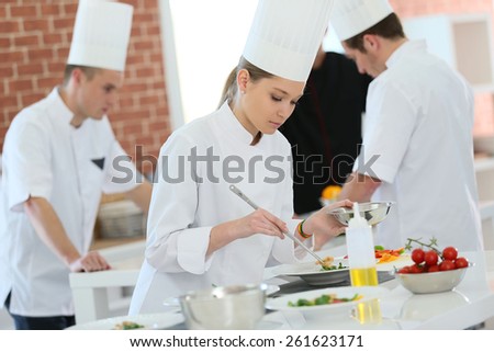 Girl in cooking training class preparing dish