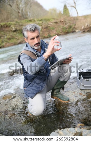 Biologist testing quality of natural water