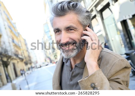 Mature man talking on the phone in the street