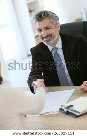 Attorney shaking hand to client after meeting