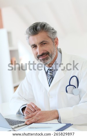 Doctor working in office on laptop