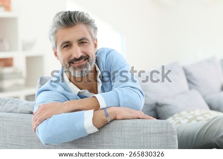 45-year-old man relaxing in sofa at home