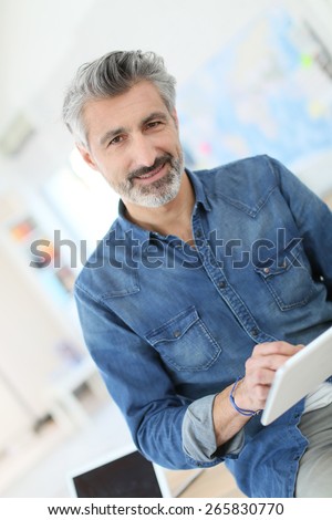 Teacher using tablet in university class