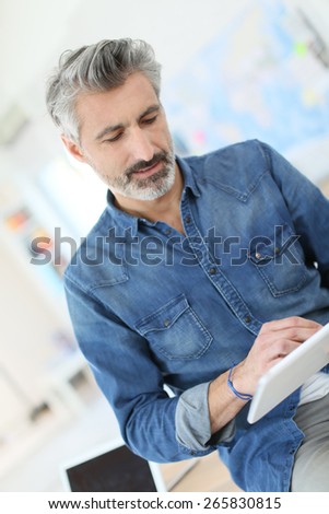 Teacher using tablet in university class