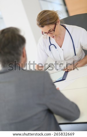 Doctor meeting with patient in hospital office