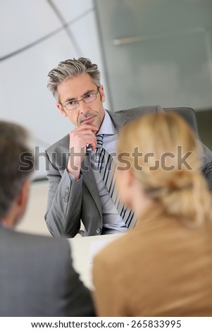 Consultant listening to clients in meeting