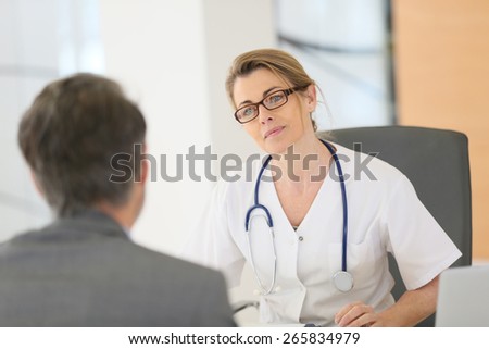 Doctor meeting with patient in hospital office