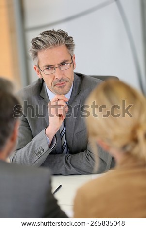 Consultant listening to clients in meeting
