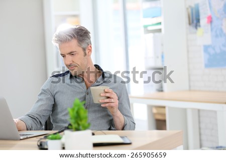 Relaxed man working form home on laptop