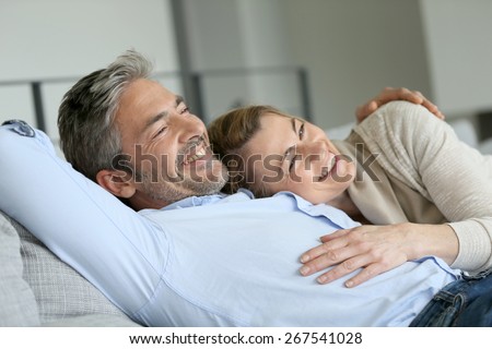 Mature couple relaxing in sofa, peaceful scene