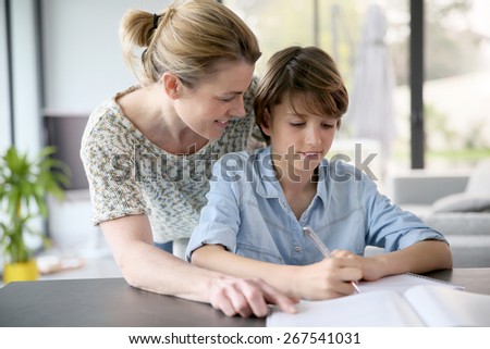 Mother helping kid with homework
