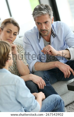 Parents having a talk with teenage boy