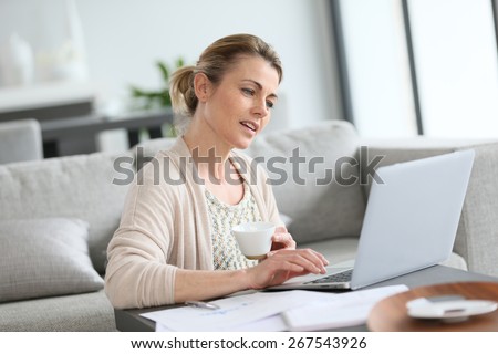 Middle-aged woman working from home on laptop