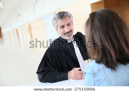 Lawyer meeting client in courthouse before trial